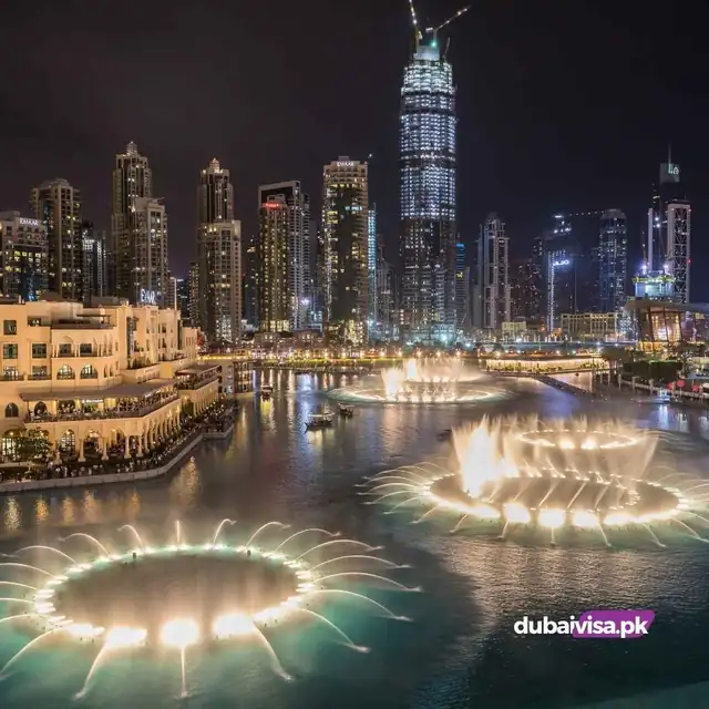 The Dubai Fountain show lit up at night in Downtown Dubai