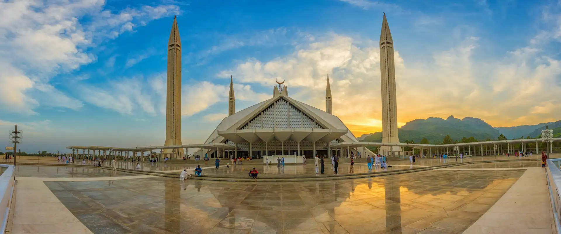 Faisal Mosque in Islamabad at sunset, with the Margalla Hills behind